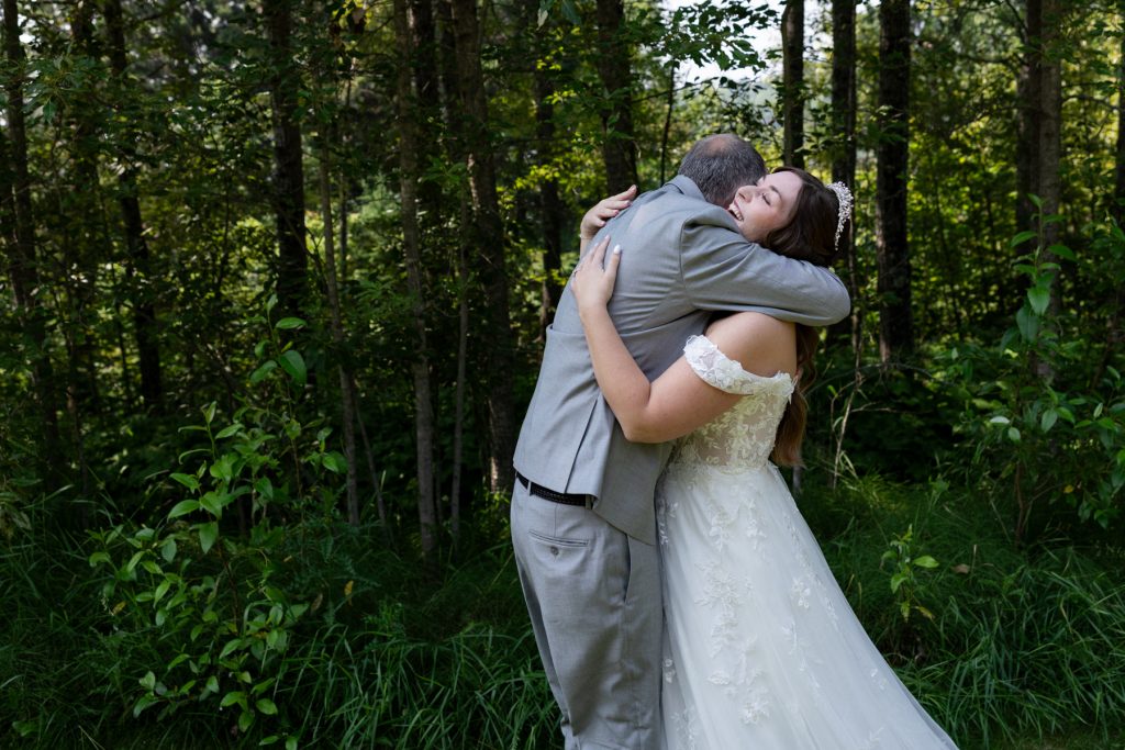 Bride and groom embrace in a forest setting, captured by Beau Petersen Photography