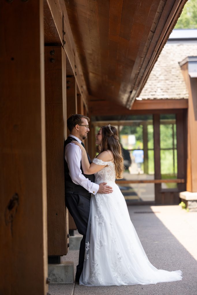 Bride and groom embracing tenderly in a rustic outdoor setting, captured by a Wisconsin wedding