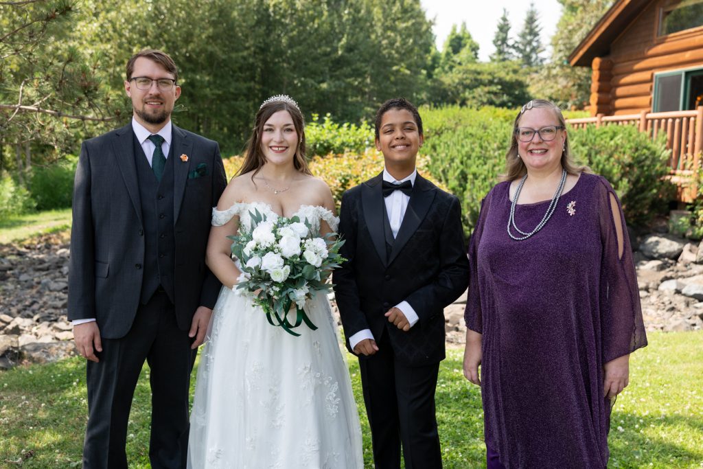 Bride and groom posing with family at a Wisconsin wedding, showcasing Beau Petersen Photography's wedding