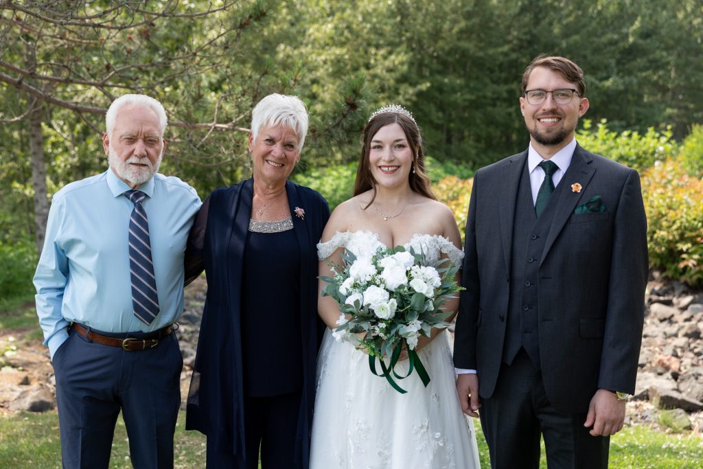Bride and groom posing with parents at a Wisconsin wedding, captured by Beau Petersen Photography