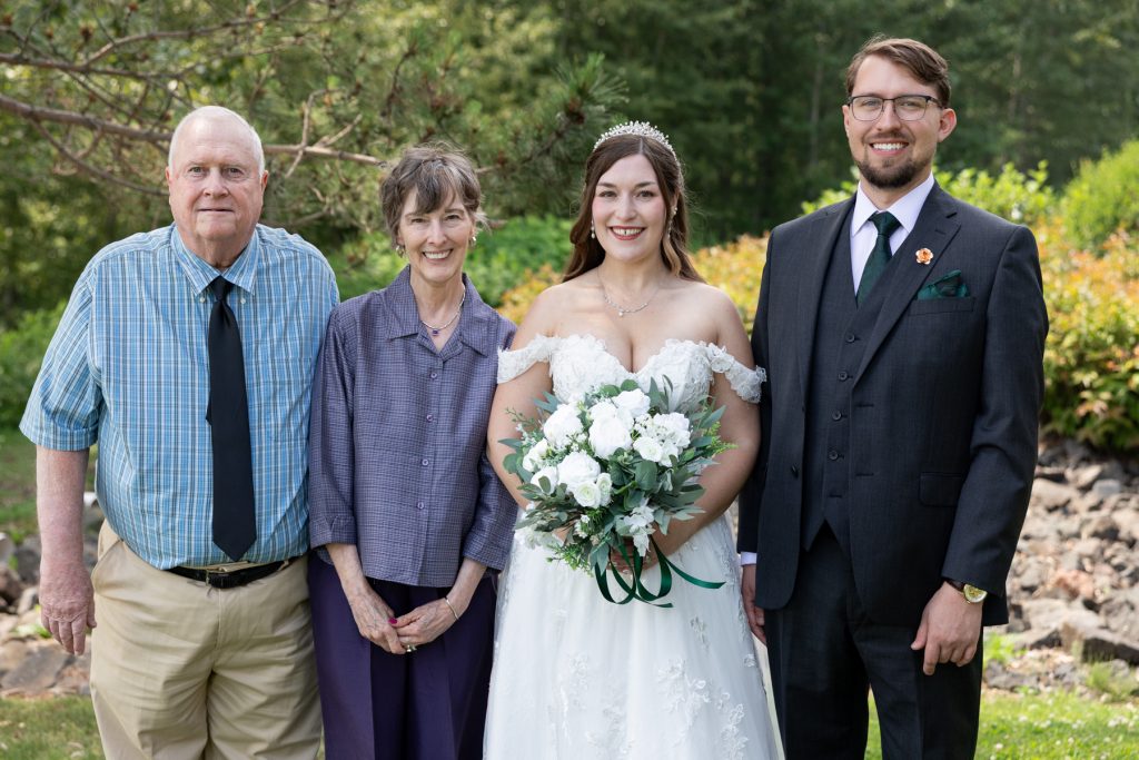Bride and groom pose with parents at Wisconsin wedding, captured by Beau Petersen Photography
