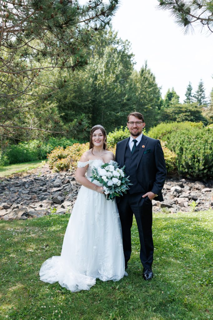 Newly married couple posing for wedding photography in Wisconsin, the bride in an off-the-shoulder gown
