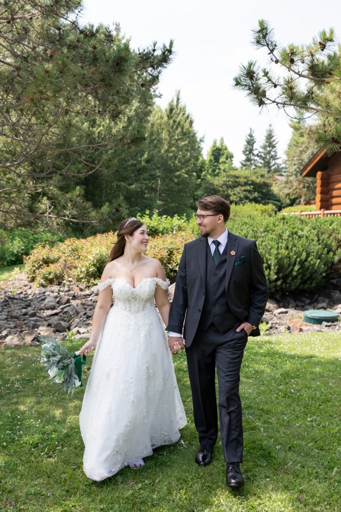 Newly married couple holding hands and smiling, captured by Beau Petersen Photography, showcasing Wisconsin wedding