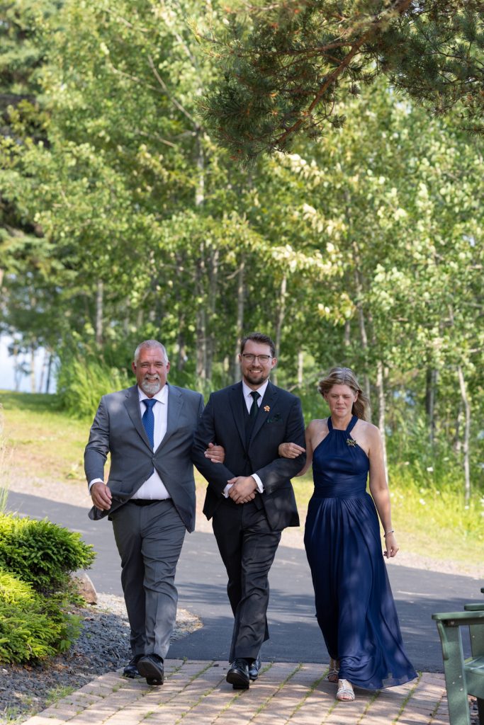Wedding party walking down a path near a lake in Wisconsin and Minnesota, captured