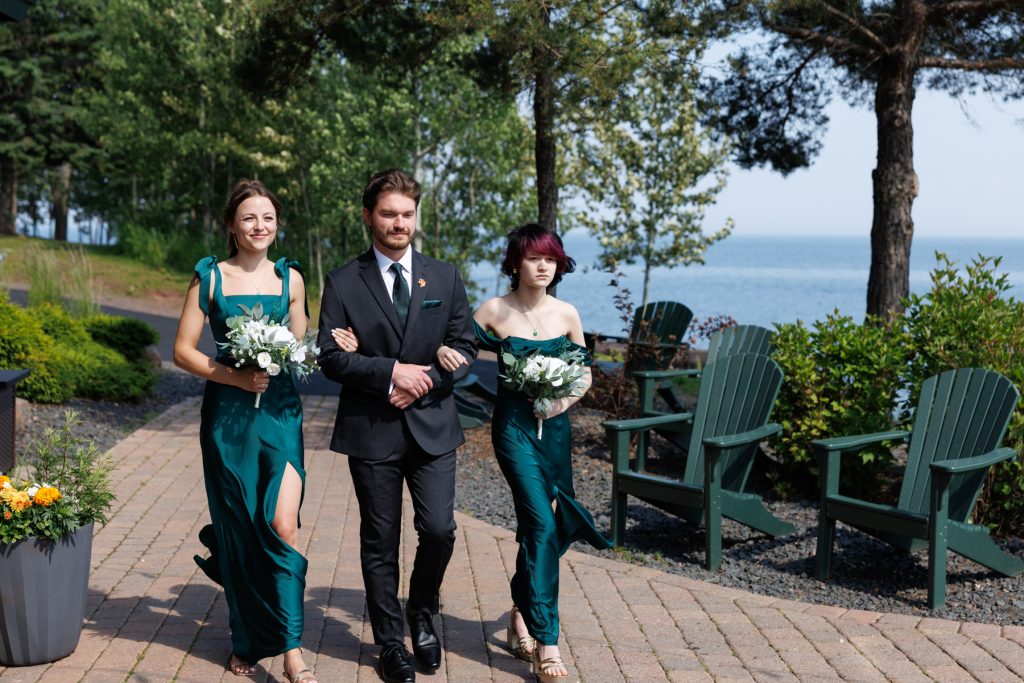 Bride and groomsmen walking down a stone pathway during a Wisconsin wedding ceremony near Hayward