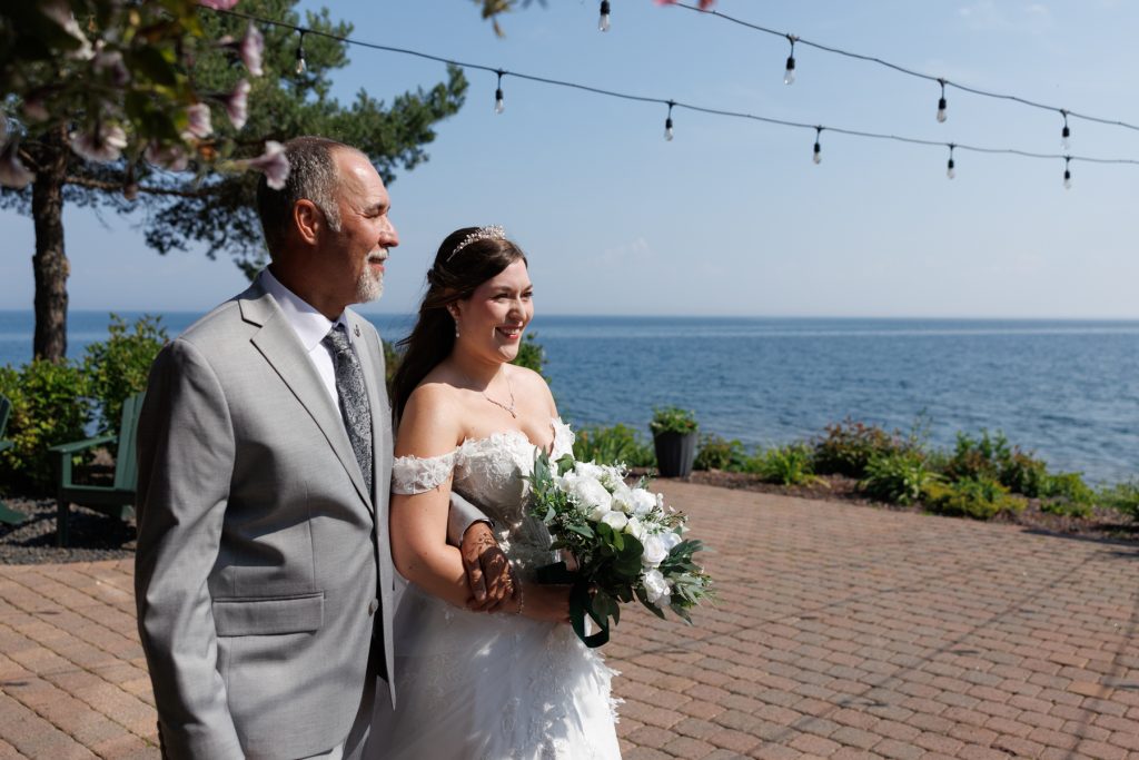Bride in a white wedding dress and groom walking together outdoors during a wedding ceremony