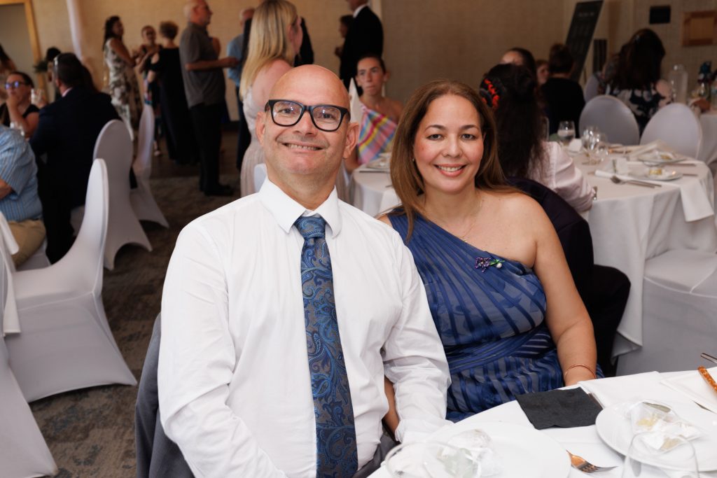 Couple smiling and posing for a wedding photo at a reception in Hayward, Wisconsin, captured