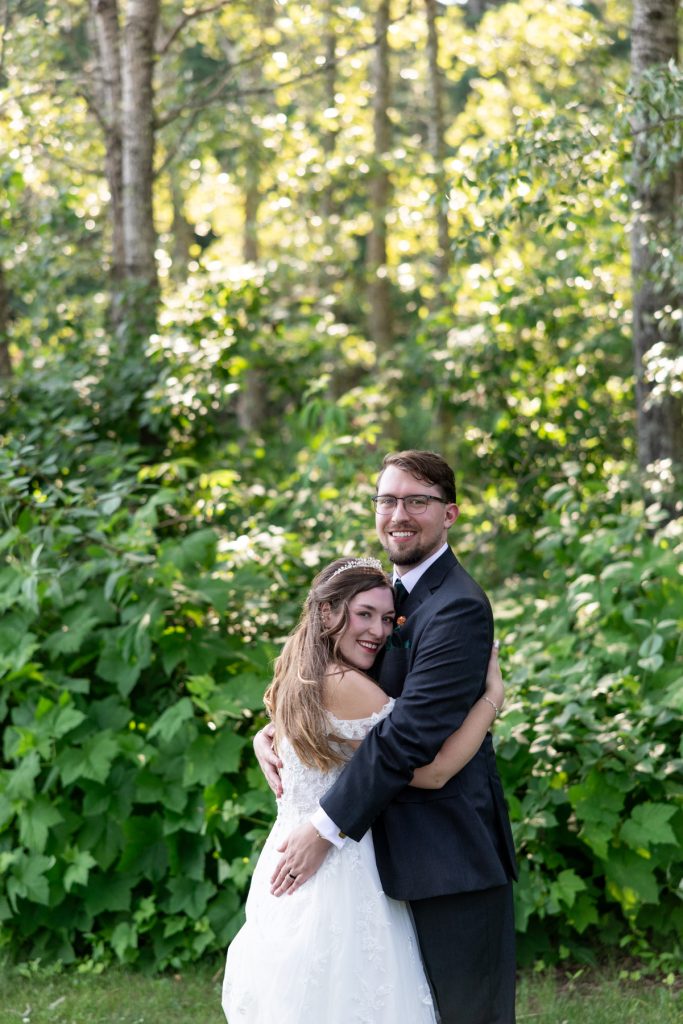 Newly married couple embracing in a wooded setting, captured by Beau Petersen Photography, showcasing Wisconsin
