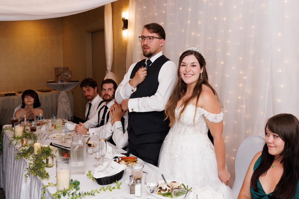 Newly married couple celebrating at their wedding reception in Hayward, Wisconsin, with guests seated