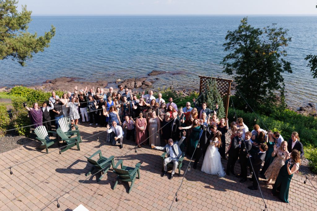 Large group wedding photo on Wisconsin’s North Shore with a bride in a white dress