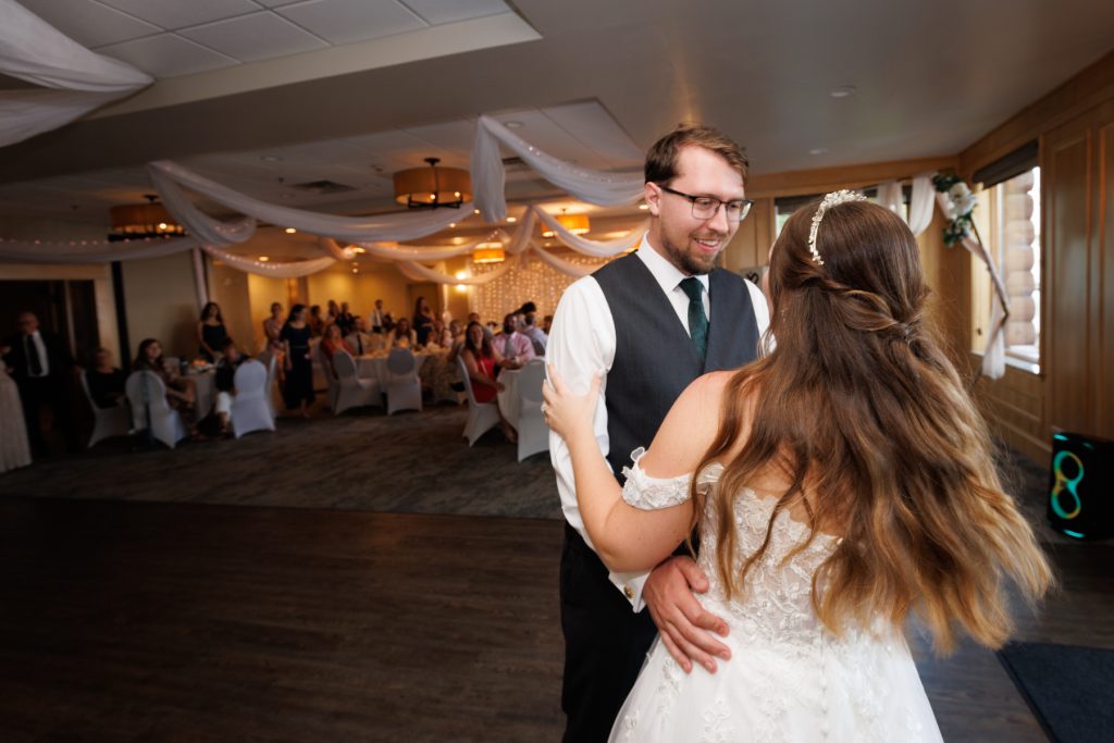 Bride and groom sharing a joyful first dance at a Wisconsin wedding reception, captured