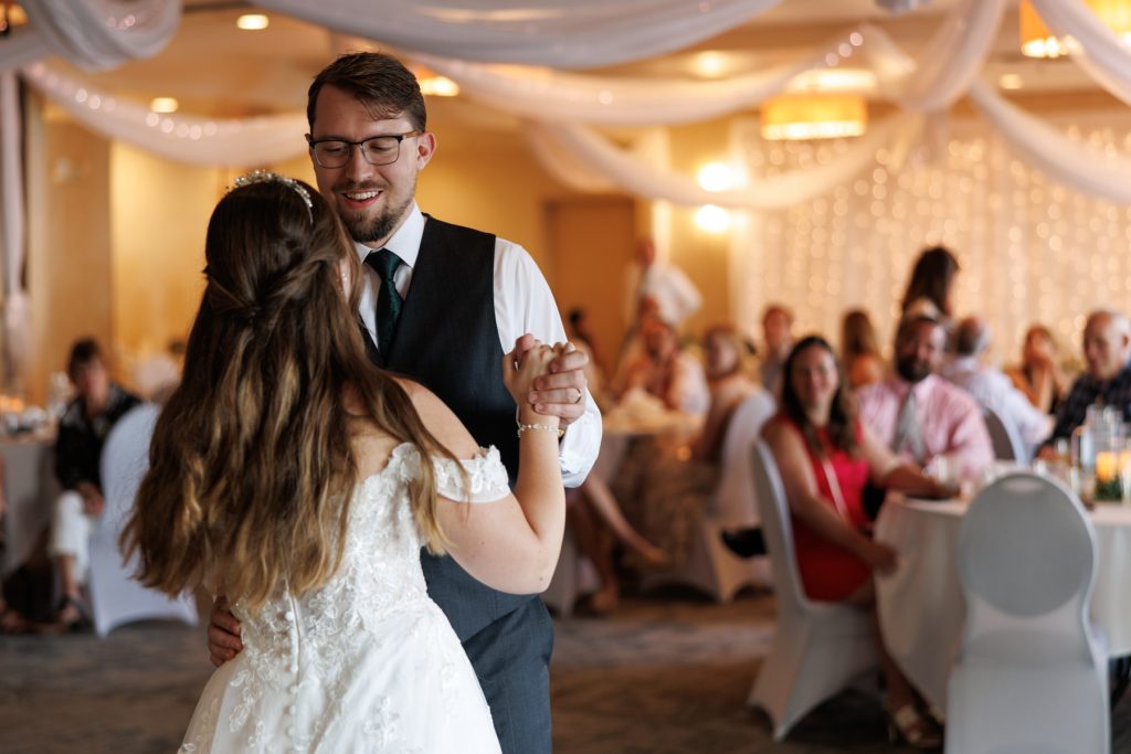 Newly married couple dancing joyfully at their wedding reception in Hayward, Wisconsin, captured by Beau