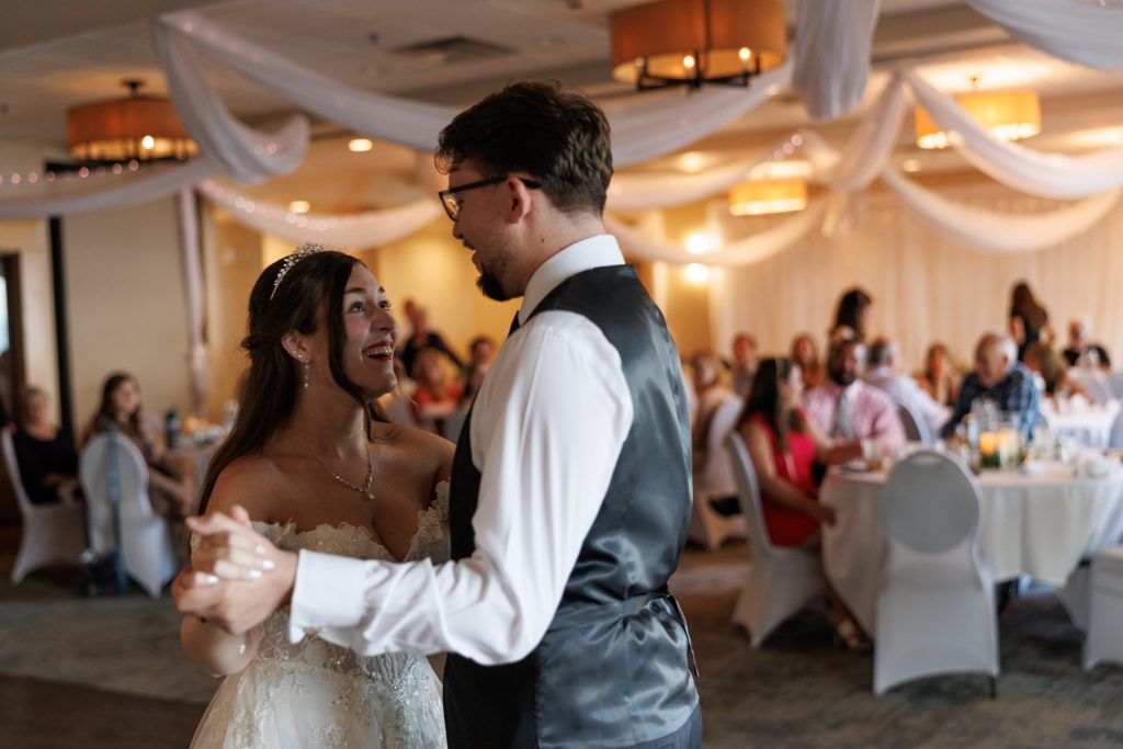 Bride and groom sharing a joyful moment during their first dance at a Wisconsin wedding