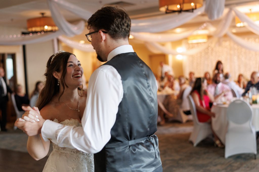 Couple joyfully dancing during their first wedding dance at a Wisconsin wedding reception, captured
