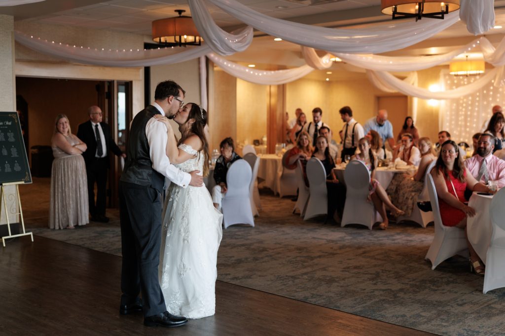 Bride and groom sharing a romantic first dance at a Wisconsin wedding reception, surrounded