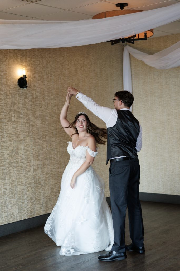 Bride and groom joyfully dancing at their wedding reception in Hayward, Wisconsin, captured by Beau