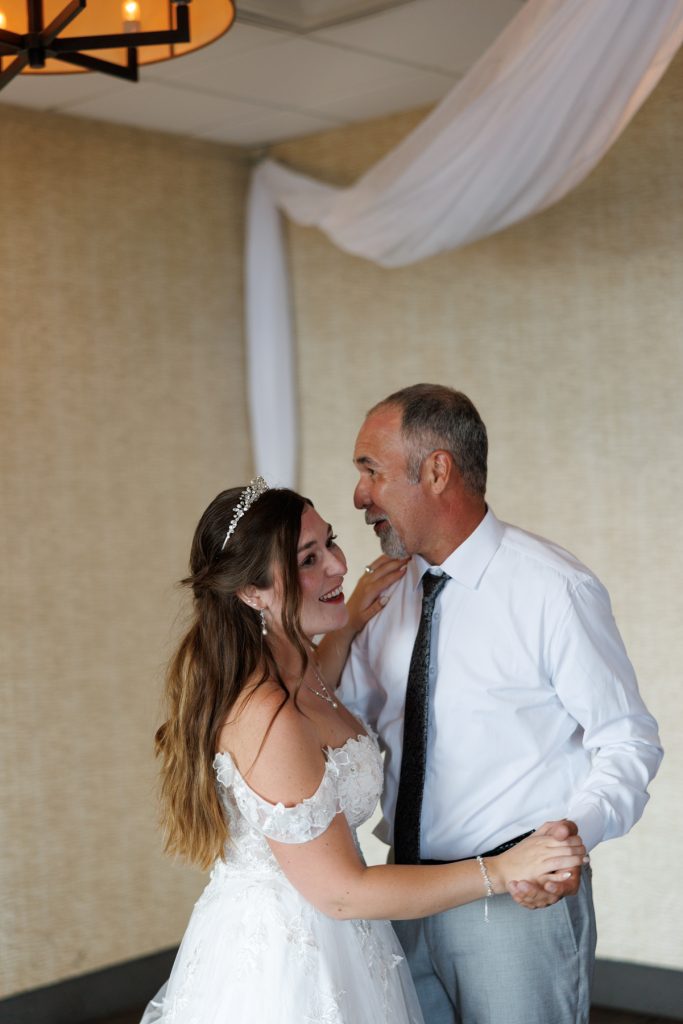 Bride and father share a tender moment during their first dance at a Wisconsin wedding