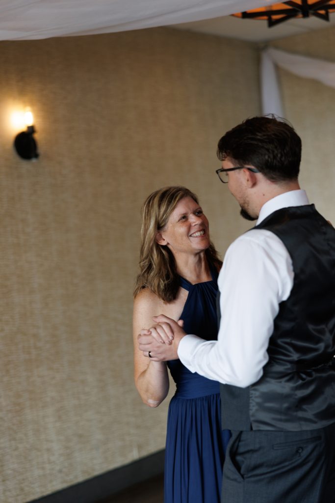 Bride and groom sharing a joyful moment during their wedding reception in Hayward, Wisconsin, captured