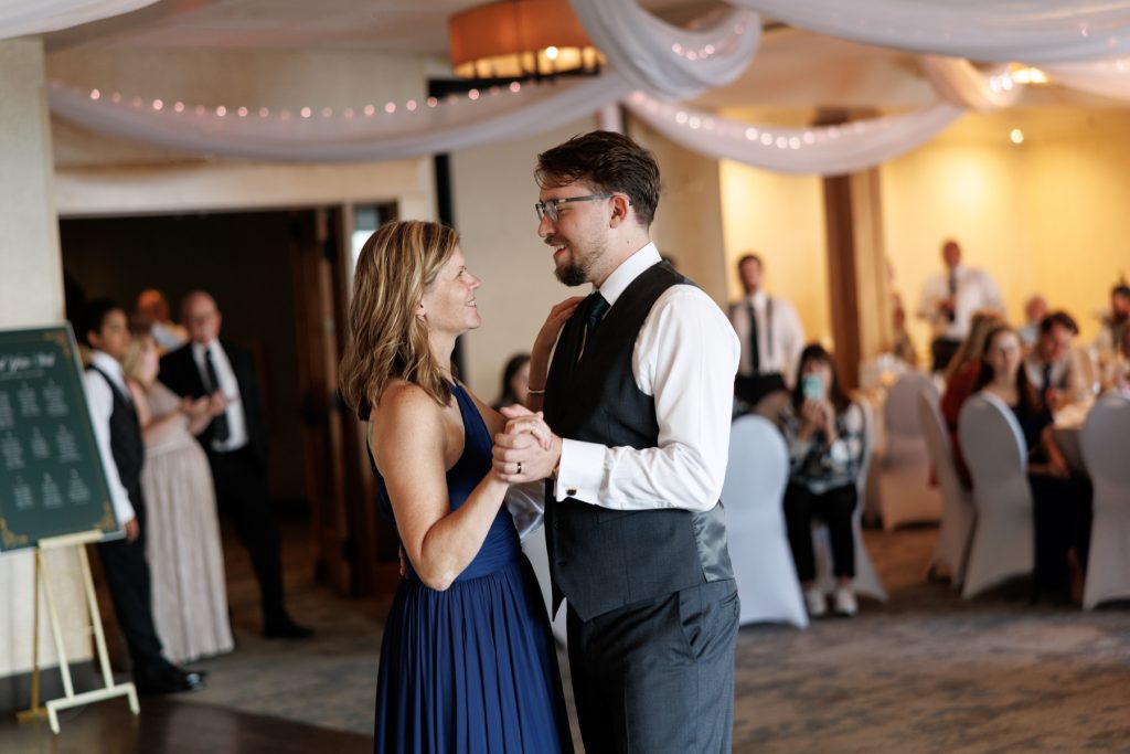 Couple sharing a joyful first dance at their wedding reception in Wisconsin, captured by Beau