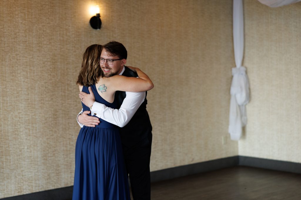 Bride and groom embrace in a heartfelt moment during their Wisconsin wedding photography and videography