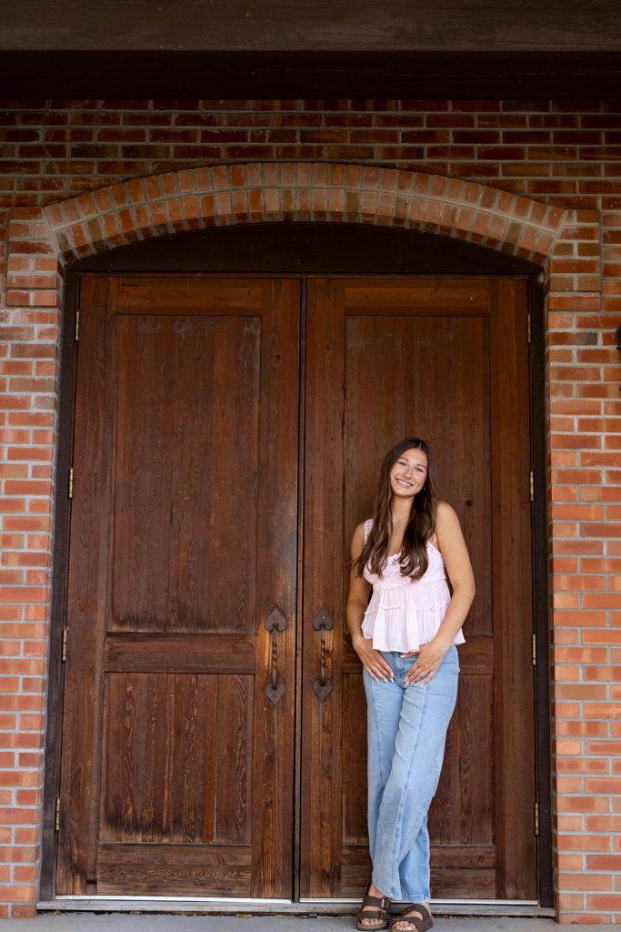 Abby, a Hayward Wisconsin High School senior, smiles confidently while posing for her portrait session