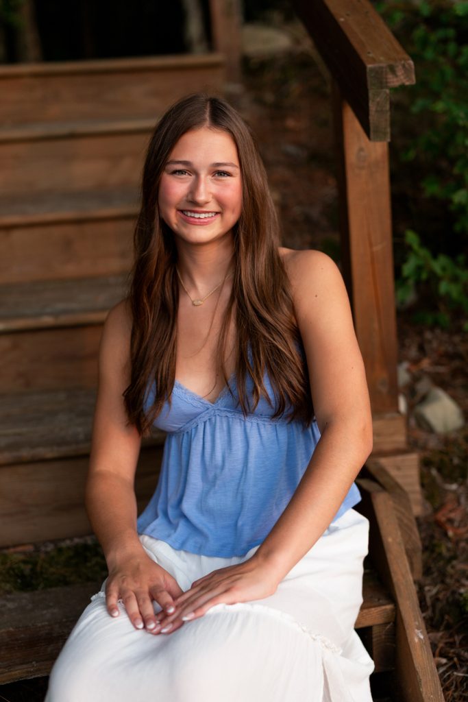 Abby, a Hayward Wisconsin High School senior, smiles warmly during her portrait session, showcasing Superior
