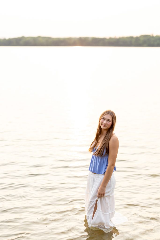Abby, a Hayward Wisconsin High School senior, smiles while posing in a flowing dress
