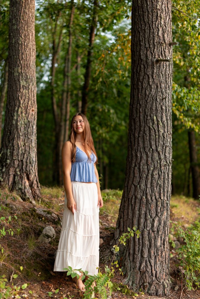 Abby, a Hayward Wisconsin High School graduate, smiles warmly during her senior portrait session