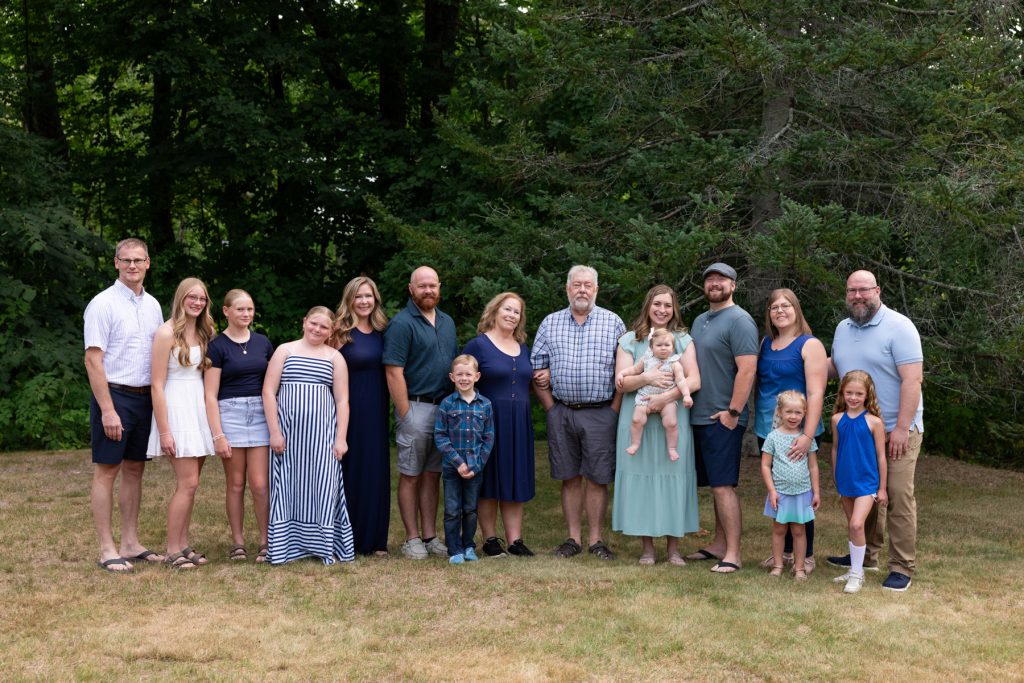 Large family portrait session capturing cherished memories of a multigenerational family gathered outdoors in Hayward