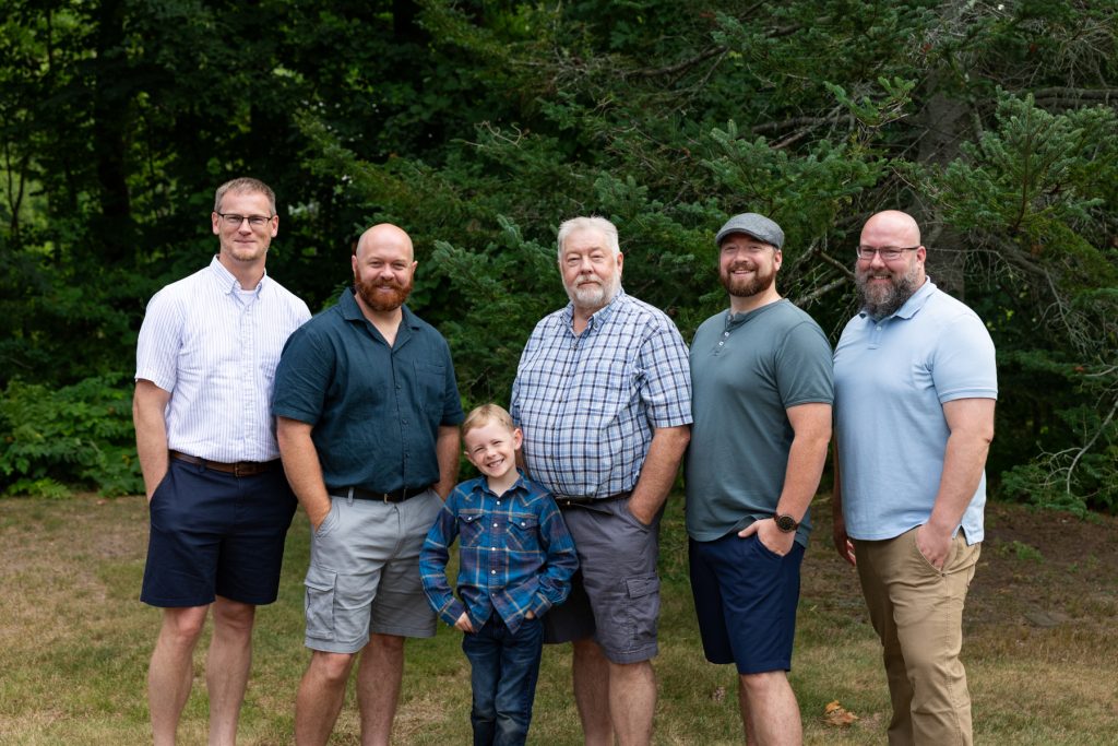 Family portrait session showcasing three generations of men and a young boy, captured by Superior