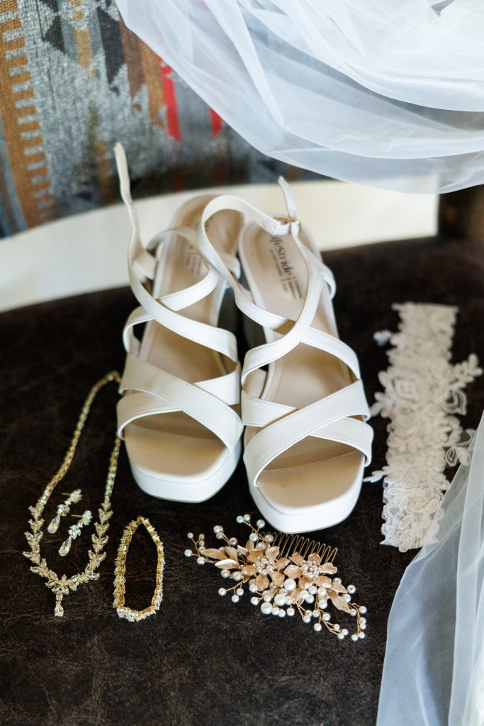Elegant white wedding shoes and delicate jewelry details from Bianca and Nick's destination wedding