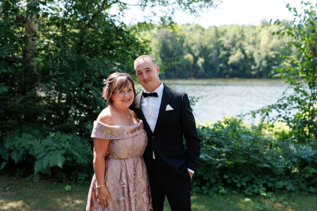 Bride's parents smiling together at a Lakewoods Resort wedding in Cable, Wisconsin, captured by Beau