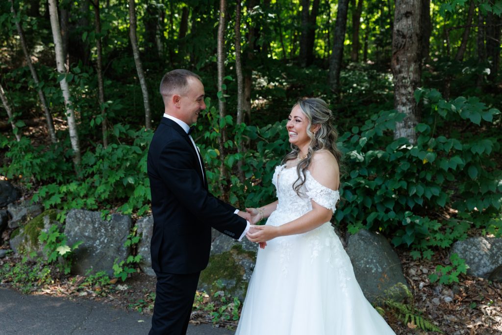 Bianca and Nick, the happy couple, share a joyful first look moment amidst the lush