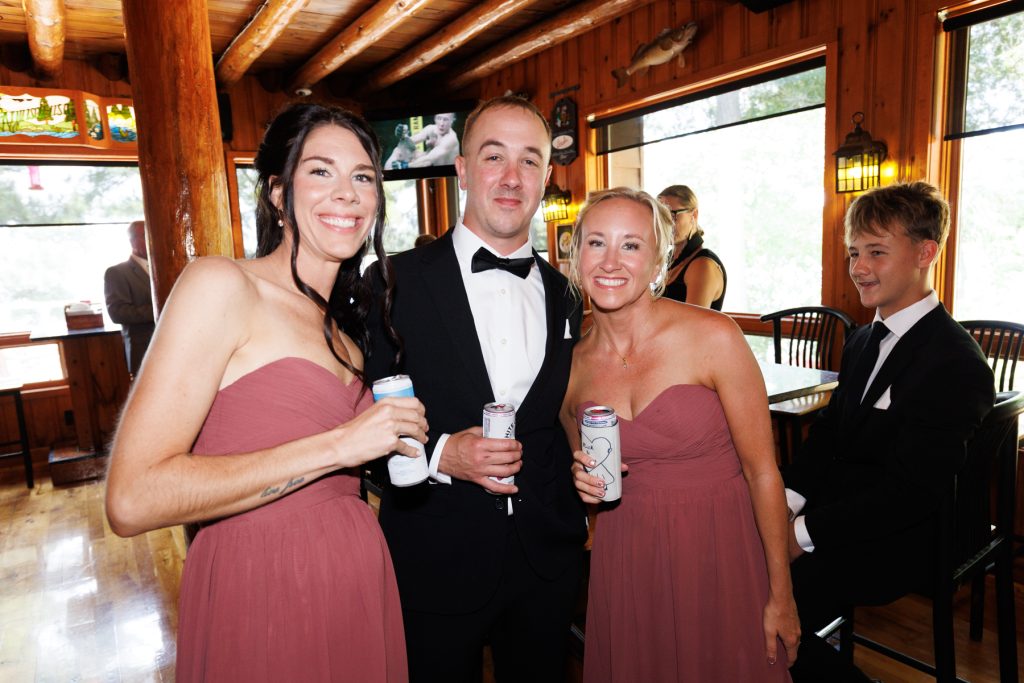 Bianca and Nick, alongside wedding party members, celebrate at the Lakewoods Resort in Cable, Wisconsin