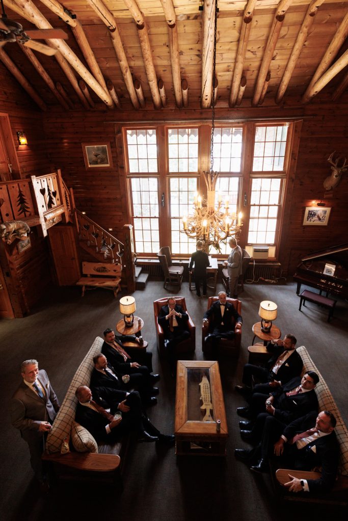 Groom and groomsmen gathered in a rustic lounge at Lakewoods Resort in Cable, Wisconsin, captured