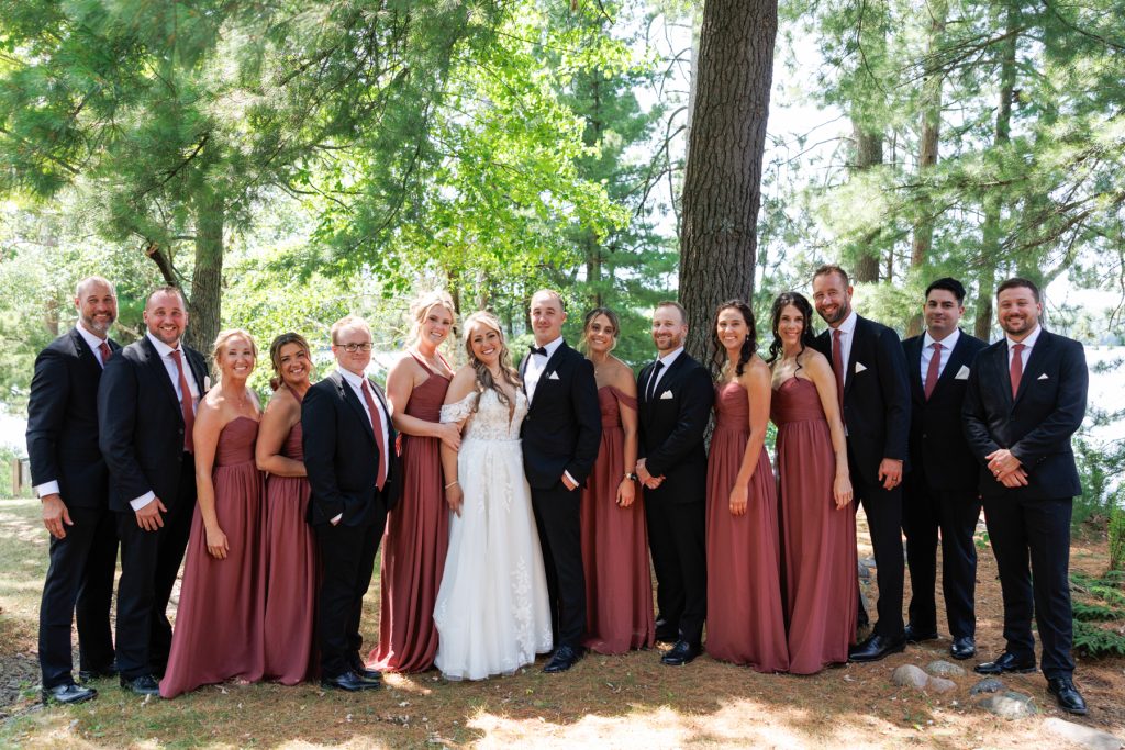 Bianca and Nick's wedding party poses for a group photo at Lakewoods Resort in Cable