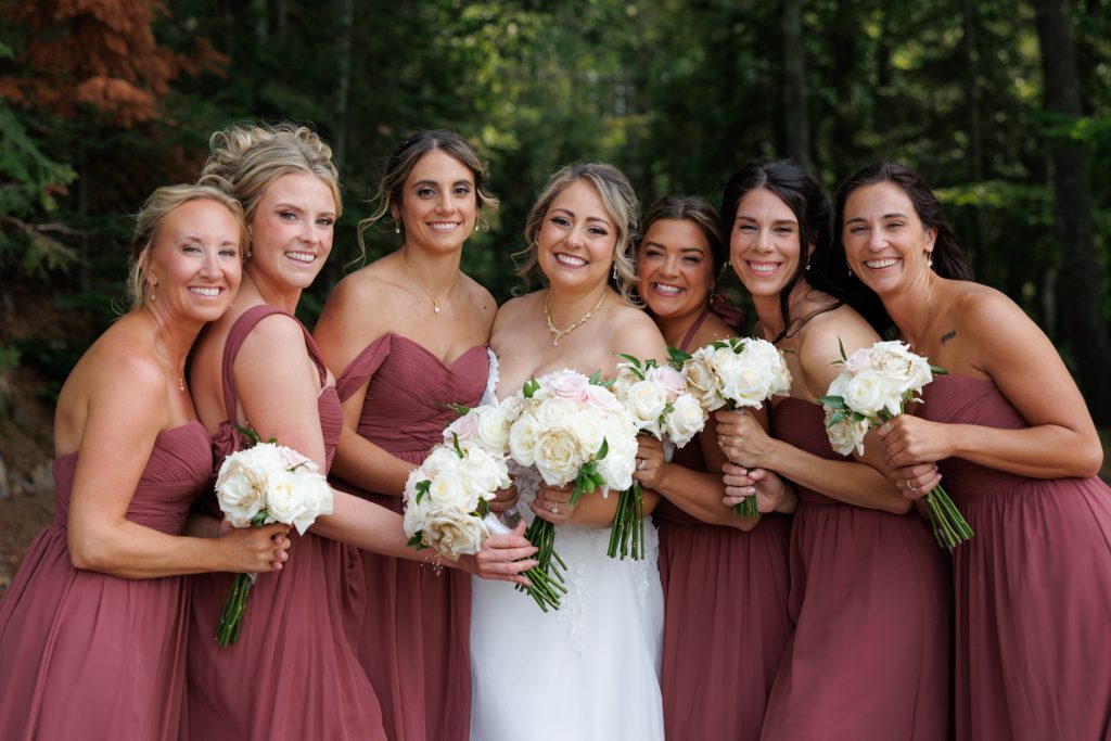 Bride and bridesmaids smiling for a portrait at a Lakewoods Resort wedding in Cable, Wisconsin