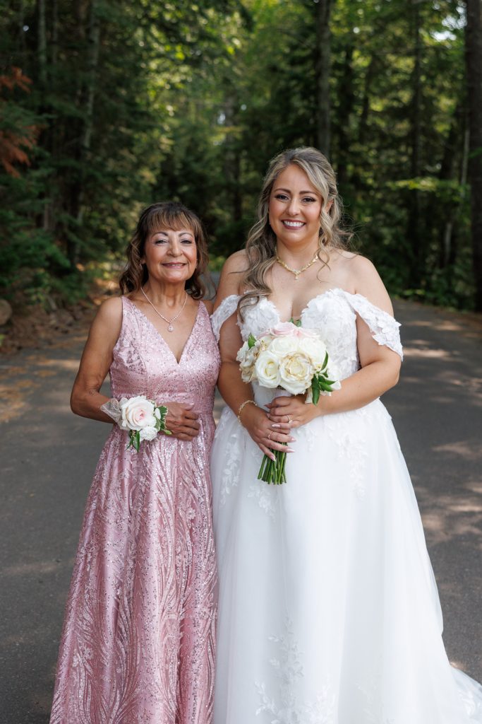 Bride and her mother pose with bouquets at a Lakewoods Resort wedding in Cable, Wisconsin