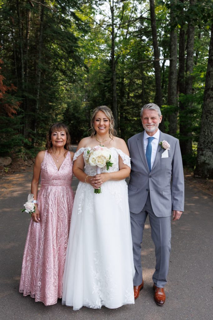 Bride Bianca poses with her parents at Lakewoods Resort in Cable, Wisconsin, captured by Beau