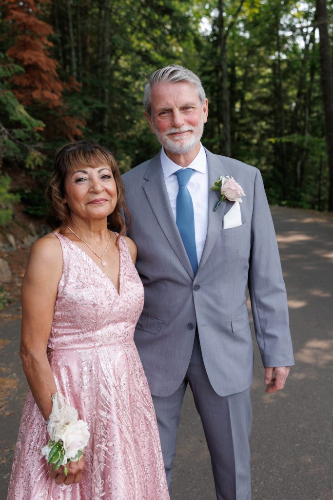Bianca and Nick, the wedding couple, pose for a portrait amidst the trees at Lakewoods