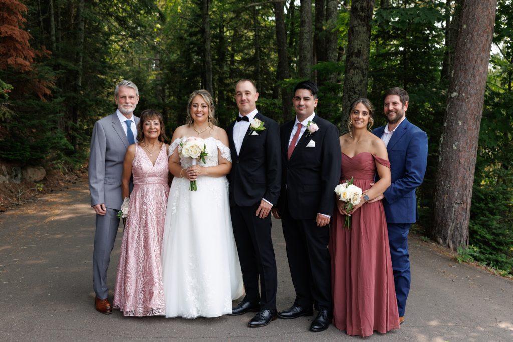 Bianca and Nick, the wedding couple, pose with their families at Lakewoods Resort in Cable