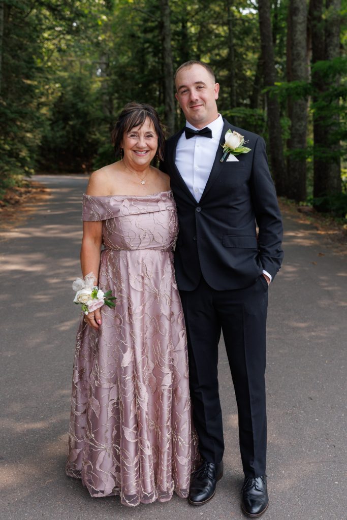 Bride’s parents smiling for a portrait at a Lakewoods Resort wedding in Cable, Wisconsin, captured