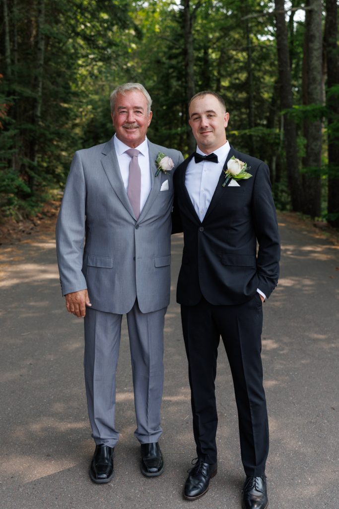 Groom and his father posing for a portrait at a Lakewoods Resort wedding in Cable
