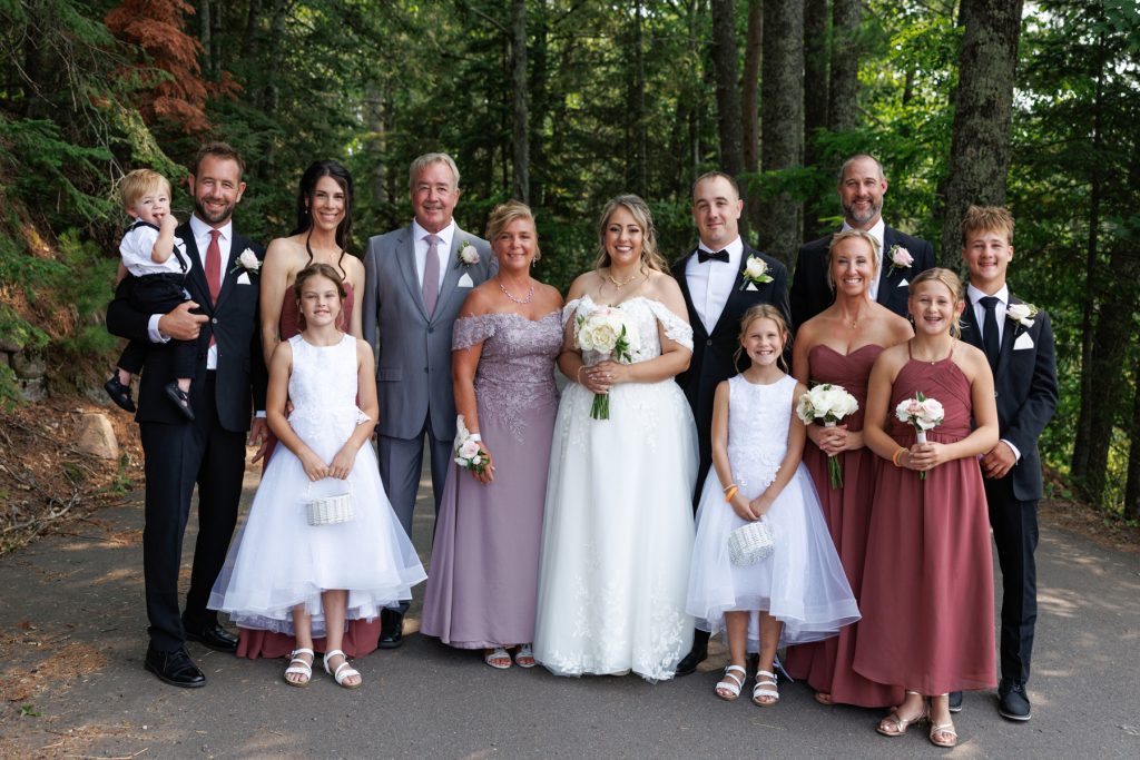 Bianca and Nick's wedding party poses for a family portrait at Lakewoods Resort in Cable
