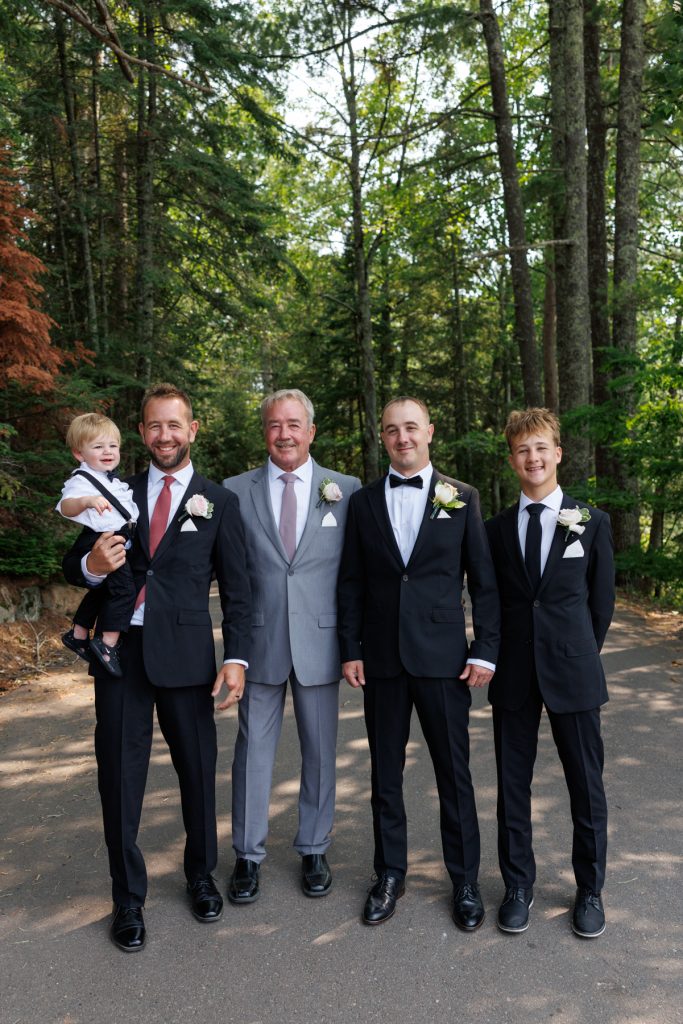 Group portrait of the groom, father, and groomsmen at a Lakewoods Resort wedding in Cable