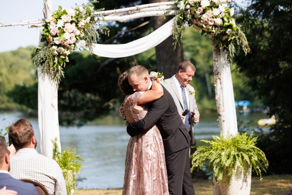 Bianca and Nick embrace during their Lakewoods Resort wedding ceremony in Cable, Wisconsin, captured
