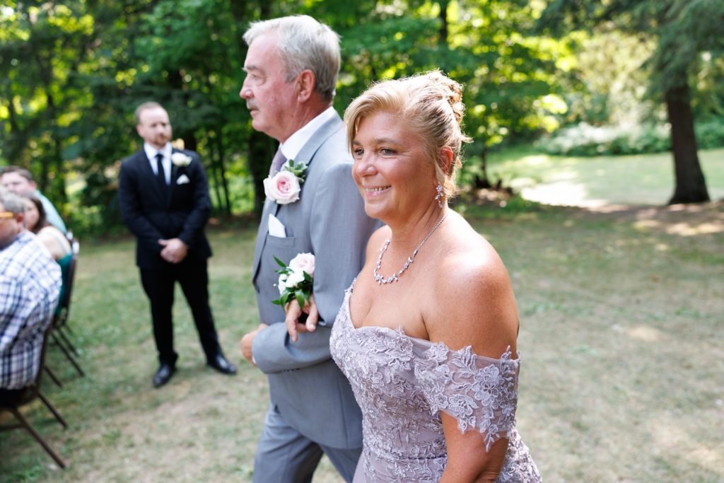 Bride and her parents walking down the aisle at a Lakewoods Resort wedding in Cable