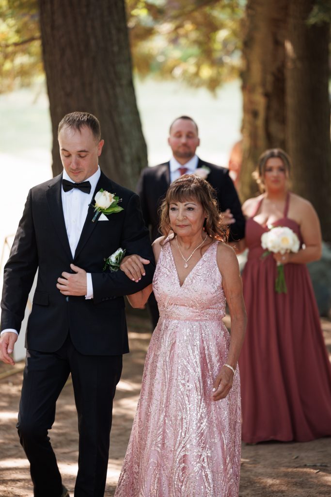 Bride's mother walking her daughter down the aisle at a Lakewoods Resort wedding in Cable