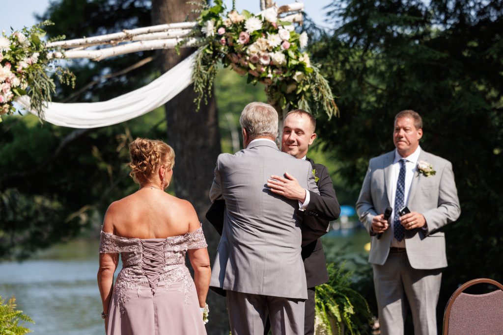 Emotional moment at a Lakewoods Resort wedding in Cable, Wisconsin, as the groom hugs