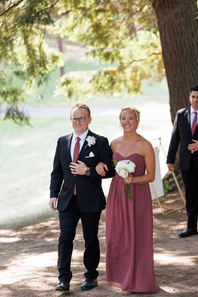 Bride and groom, Bianca and Nick, walk hand-in-hand during their Lakewoods Resort wedding in Cable